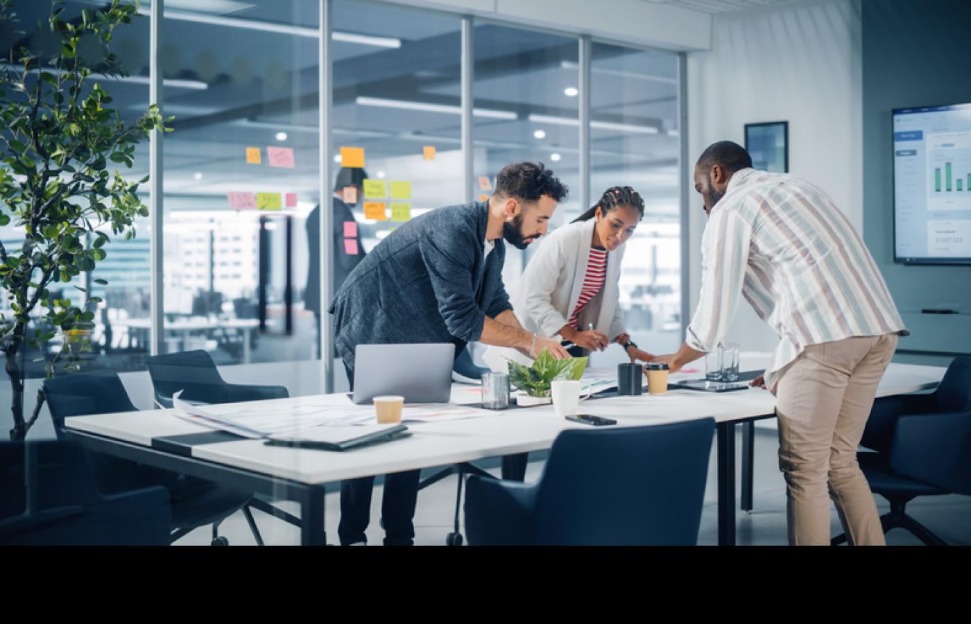 A team look over their plans at a table.
