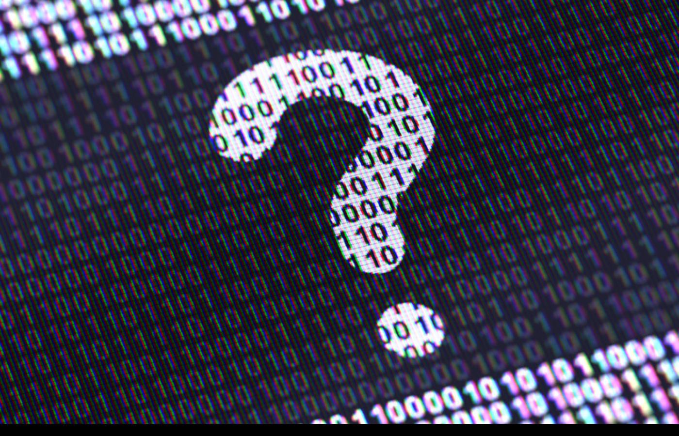 A question mark made of ones and zeros appears on a screen in black and white.
