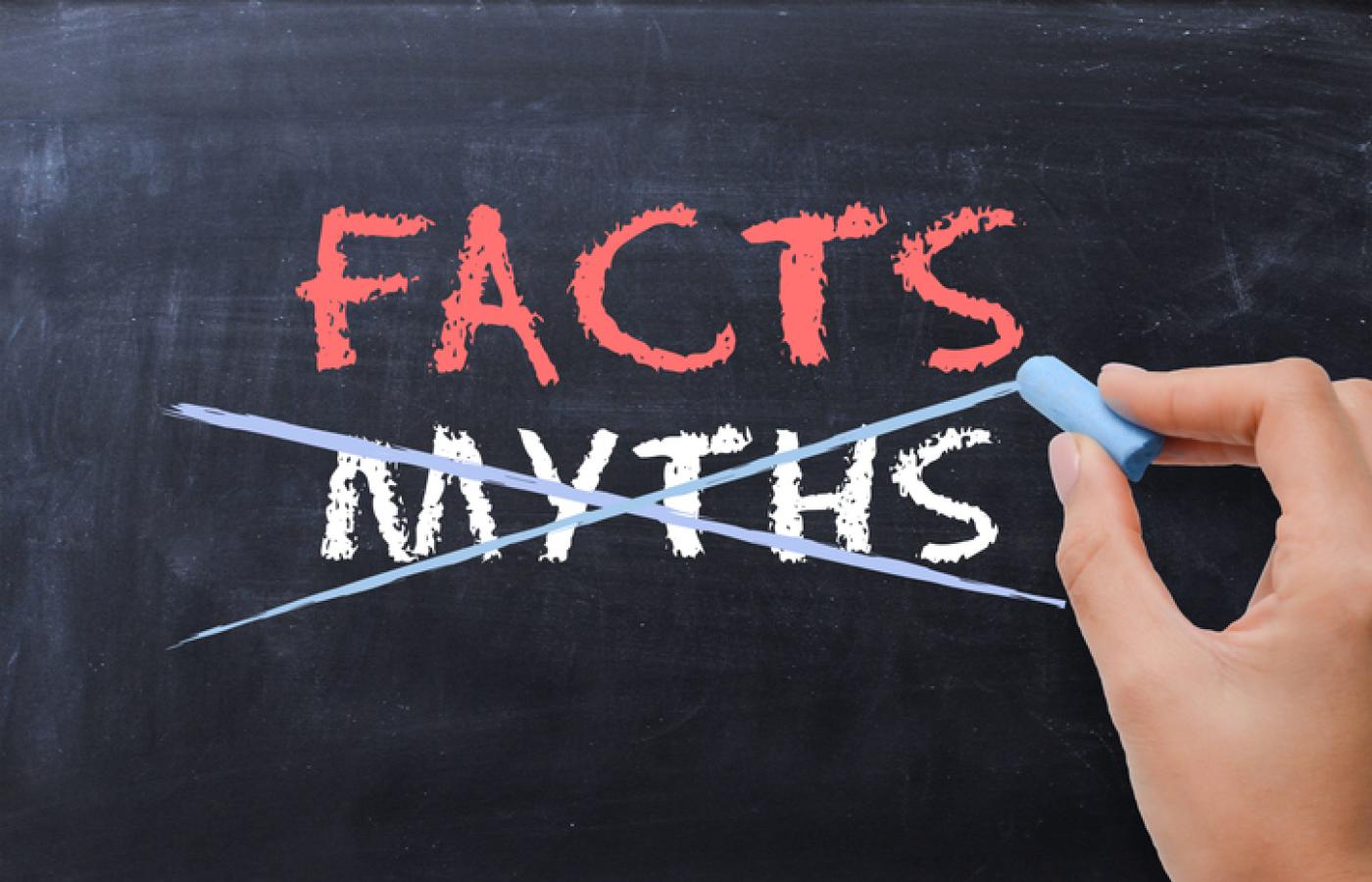 The words facts and myths are on a chalkboard and the word myths is being crossed out.