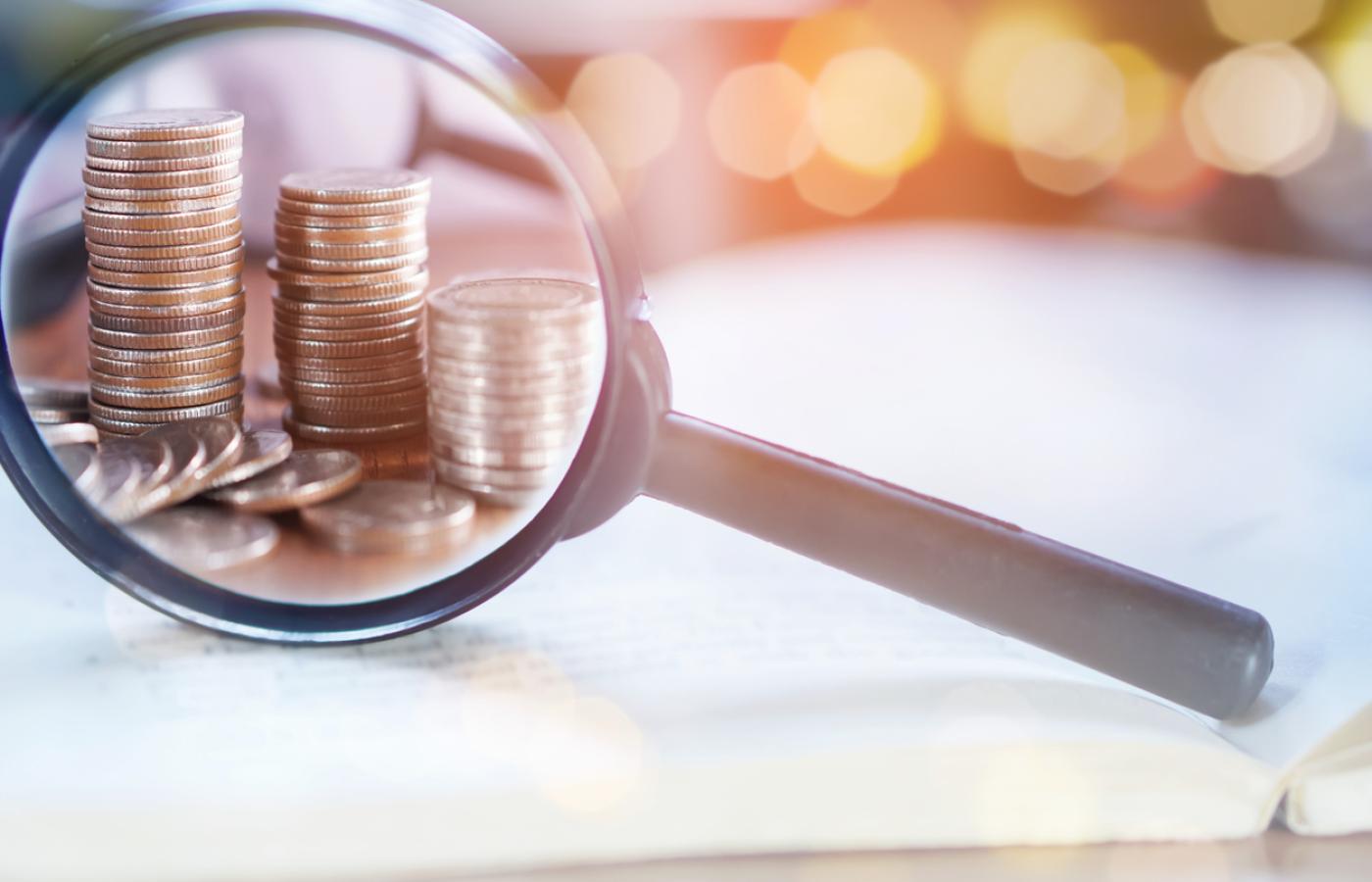 Image of magnifying glass and coins