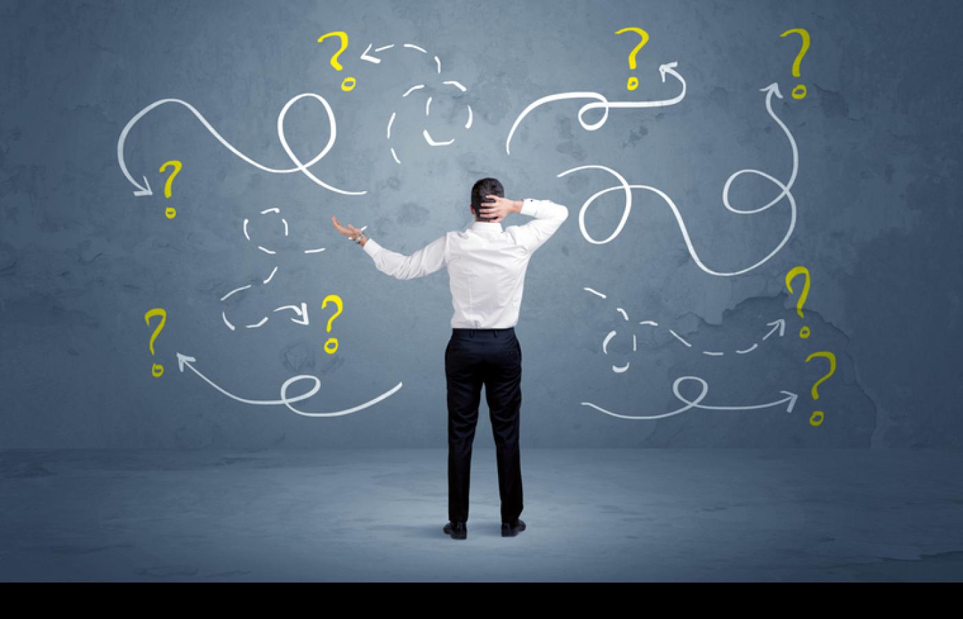 A man stands confused about design decisions.